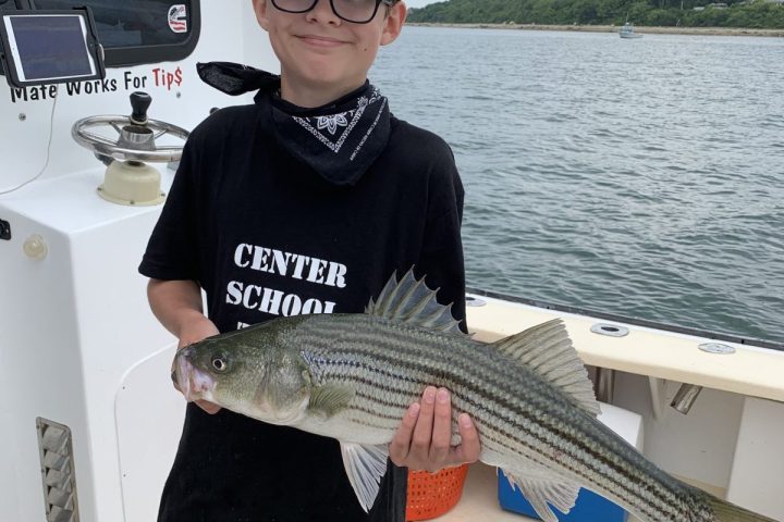 a person holding a fish in the water