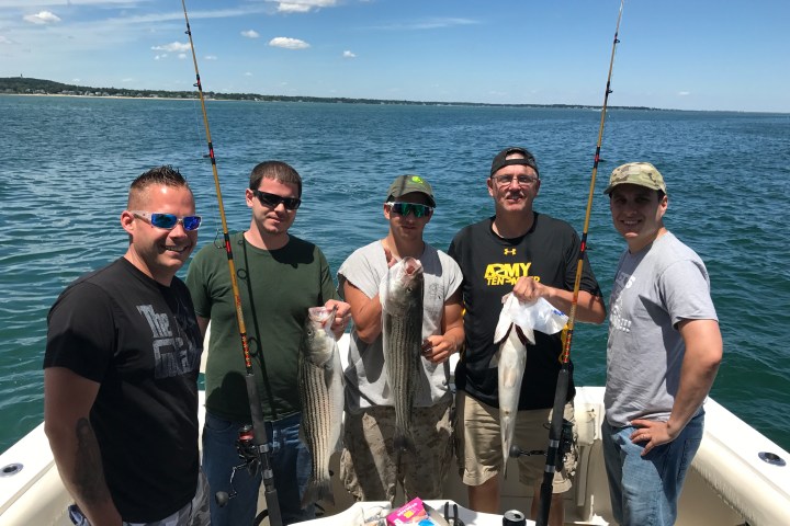 a group of people standing on a boat in the water