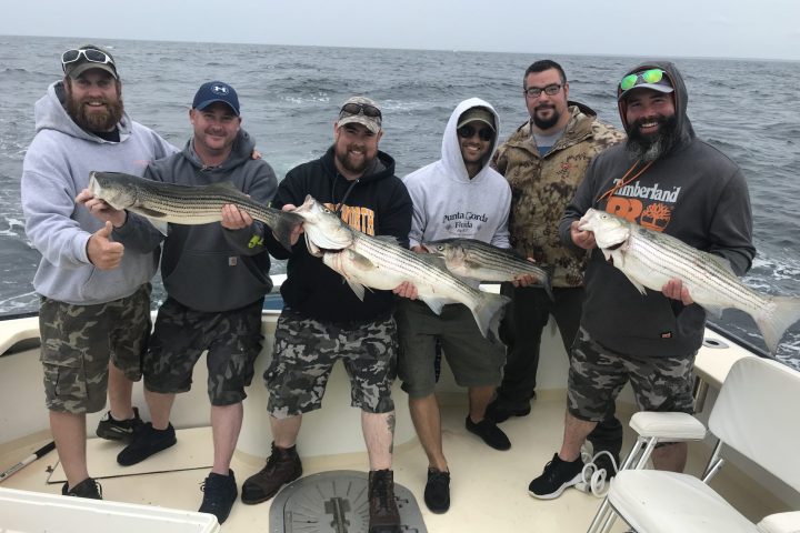 a group of people holding a fish