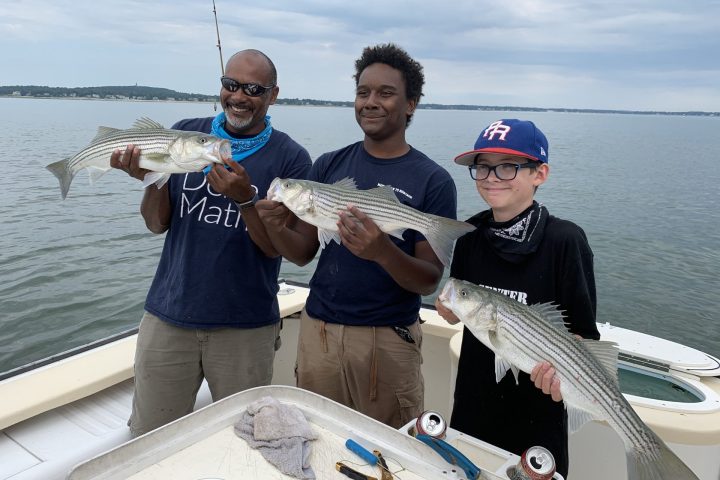 a person holding a fish on a boat in the water