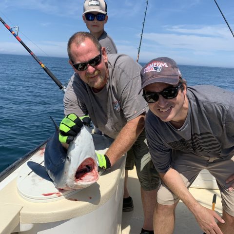 a man holding a fish in the water
