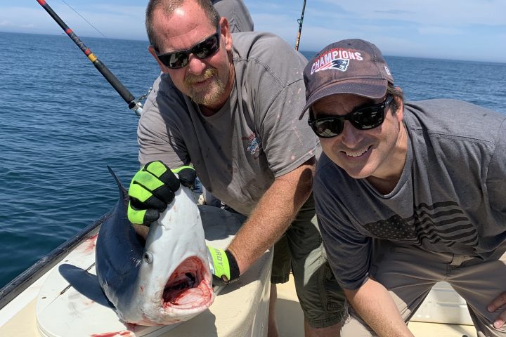 a man holding a fish in the water