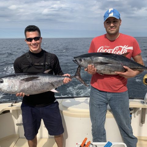 a person holding a fish in the water