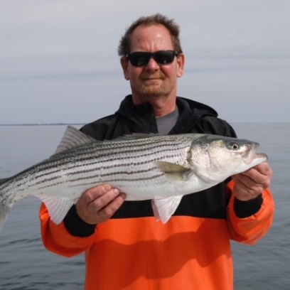 a man holding a fish in the water