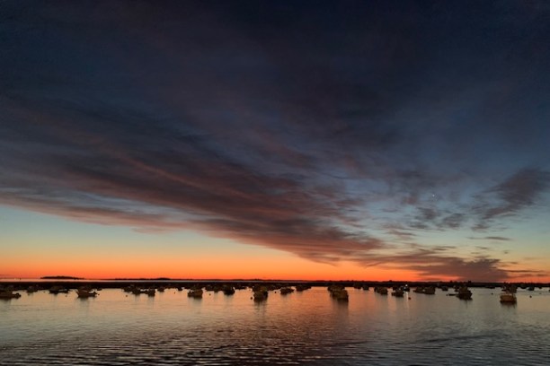 a sunset over a body of water
