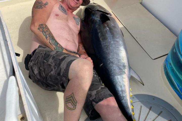 a man holding a fish