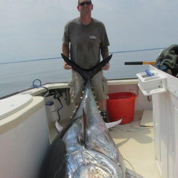 a man holding a fish in the water